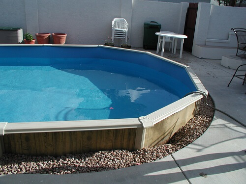 rocks around in ground above ground pool