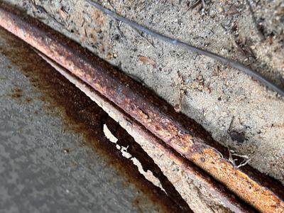 Rusted curved bottom rail