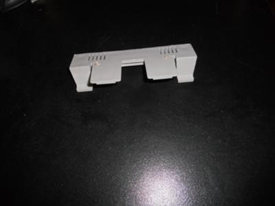 Two clips go into plate. Front view